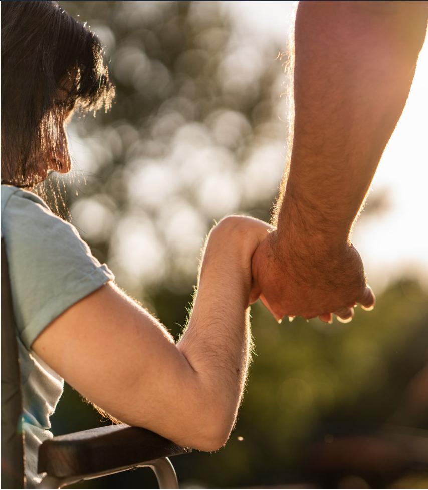 Child holding adults hand